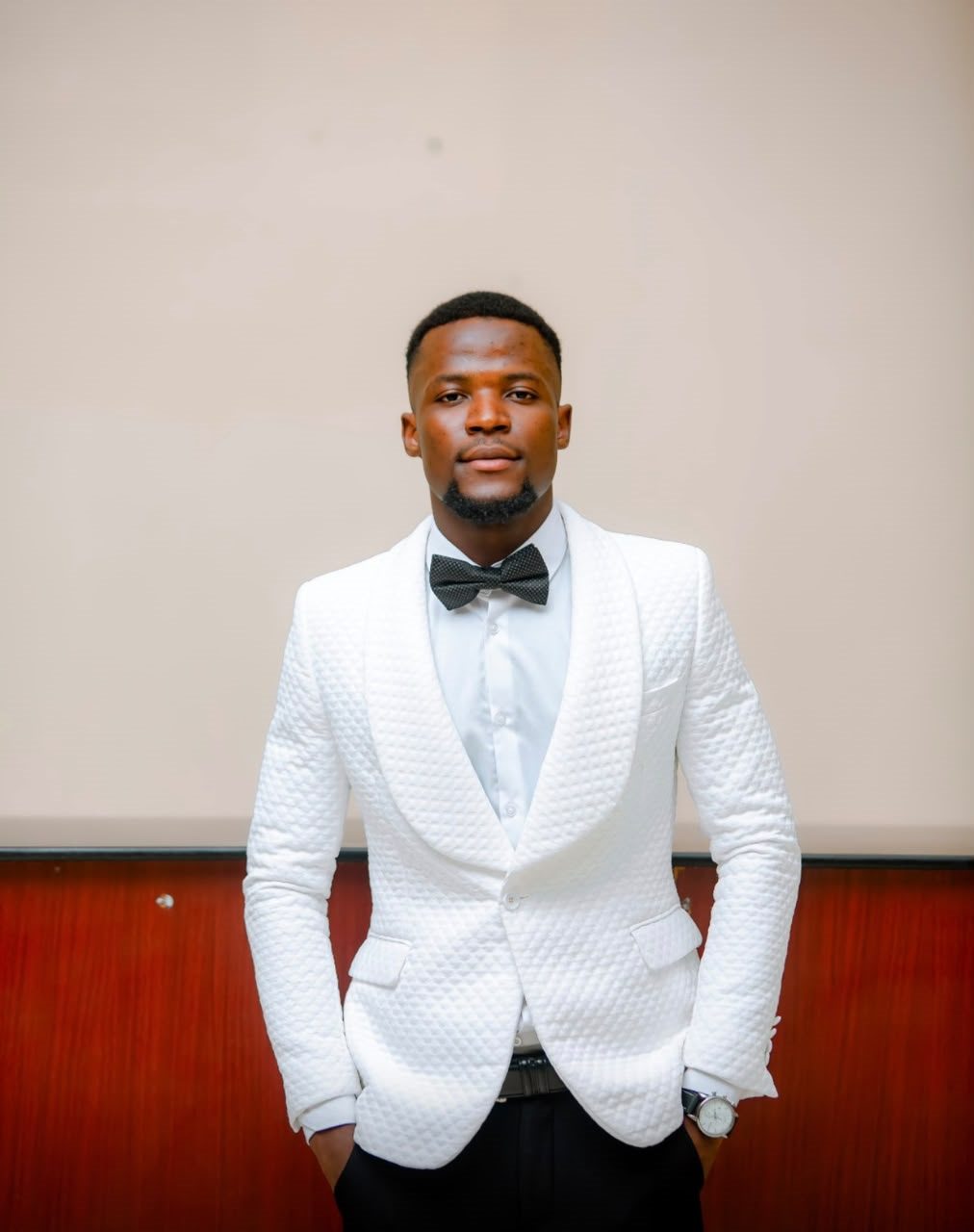 Darlington Sayee in formal white suit